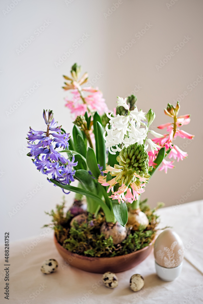 Easter composition from hyacinths flowers and quail eggs on linen tablecloth. Zero Waste Easter