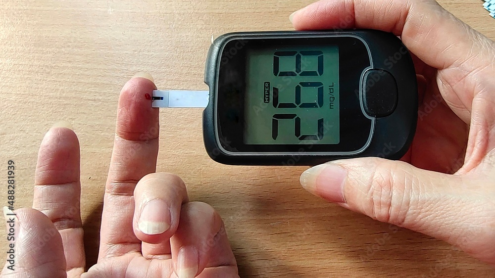 portrait fingertip checking, showing high blood sugar pressure monitor, patient diabetes take proactive control, concept health care. portrait fingertip checking, showing high blood sugar pressure monitor, patient diabetes take proactive control, concept health care.