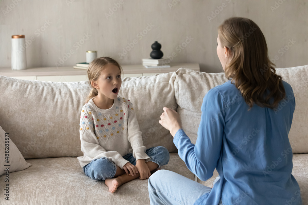 Singing teacher training student girl kid at home. Speech therapist teaching child to do voice, speaking exercises, helping to cope stutter, bad pronunciation, communication problems