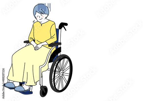 車椅子に乗り落ち込むシニア
