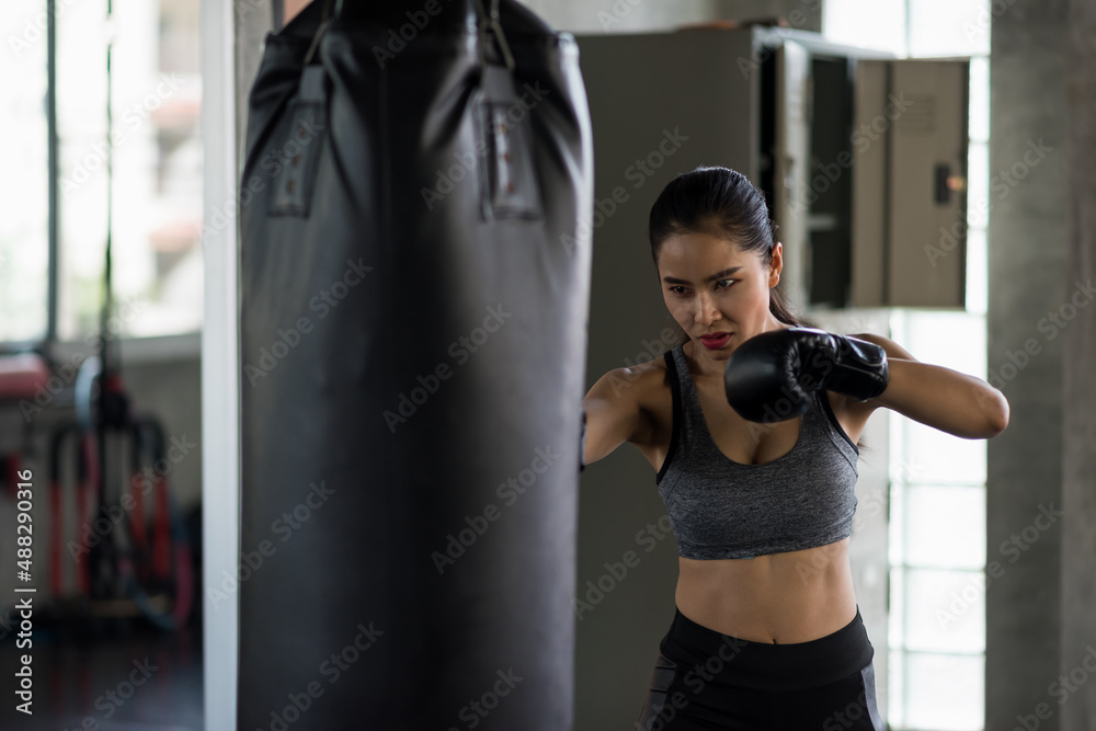Asian young woman boxing training in fitness gym
