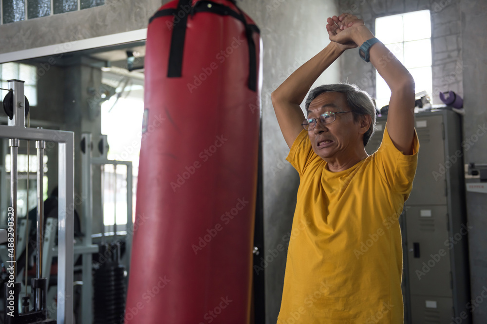 Fit old man stretching body before boxing work out