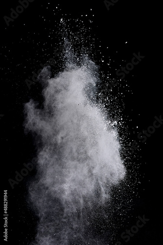 Freeze motion of white color powder exploding on dark background.