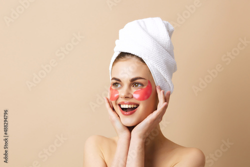 beautiful woman skin care face patches bare shoulders beige background