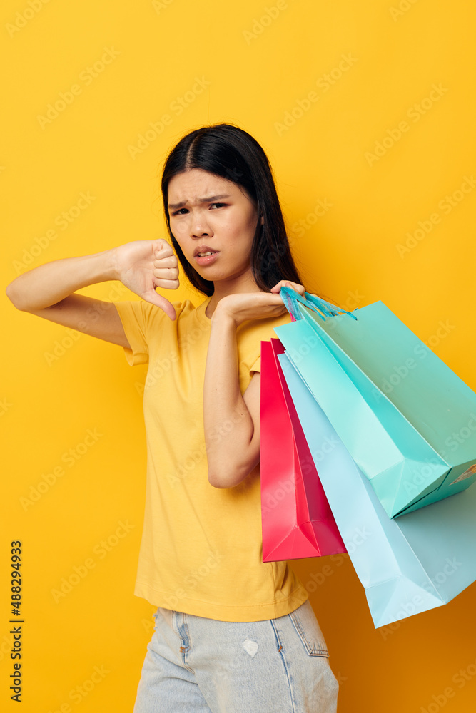 woman with Asian appearance woman with packages in hands shopping isolated background unaltered