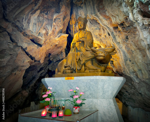 Close View Bodhisattva God Statue in Natural Cave. Perak, Malaysia photo