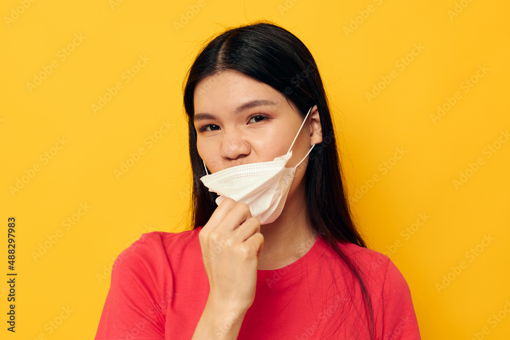 Charming young Asian woman posing medical mask close-up studio model unaltered Charming young Asian woman posing medical mask close-up studio model unaltered