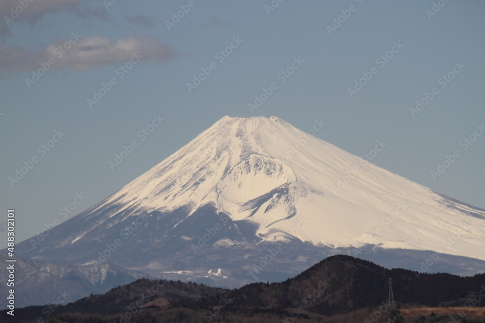 Isolated picture of the Mount Fuji in winter under a clear blue sky with snow-capped peak. Shot from Izu peninsula, Japan.