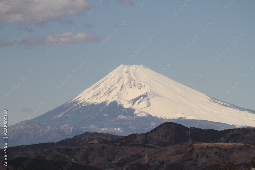 Isolated picture of the Mount Fuji in winter under a clear blue sky with snow-capped peak. Shot from Izu peninsula, Japan.