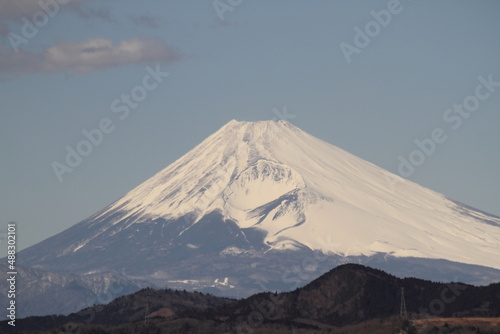 Isolated picture of the Mount Fuji in winter under a clear blue sky with snow-capped peak. Shot from Izu peninsula  Japan.