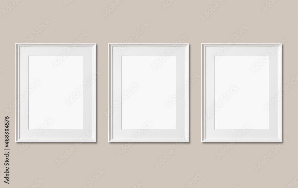 Picture frame mockup. Set of three vertical white frames on beige neutral wall background. Empty, blank template for artwork, painting or poster. Picture frame mockup. Set of three vertical white frames on beige neutral wall background. Empty, blank template for artwork, painting or poster.
