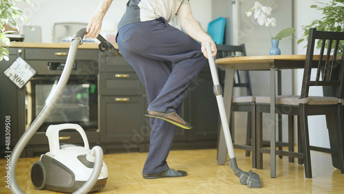 Person doing housework with vacuum cleaner and vacuuming own fart photo