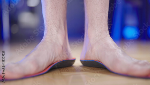 Person feet testing the arch support insole flexibility