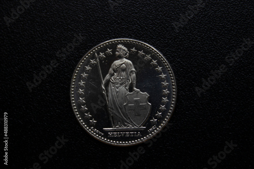 metal coin close-up on a black background.