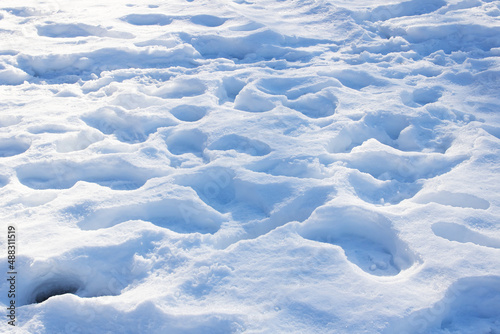 Traces of human shoes on surface of snow