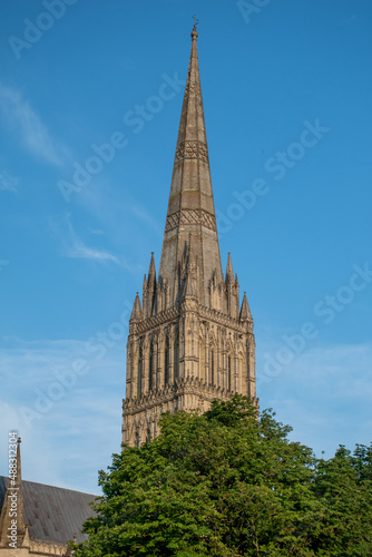 Close up of Salisbury Cathedral spire in Wiltshire, UK. Against a clear blue sky in July 2021