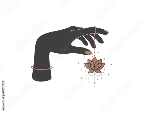Magic hand with hanging lotus flower in trendy boho style. Black and gold colored alchemy spiritual symbol for branding name and logo. Esoteric and mystical design element. Vector illustration