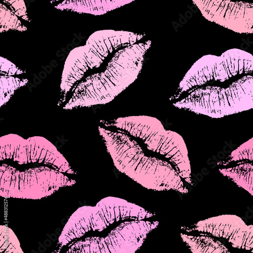 Vector seamless pattern with pink lip imprints isolated on black background.