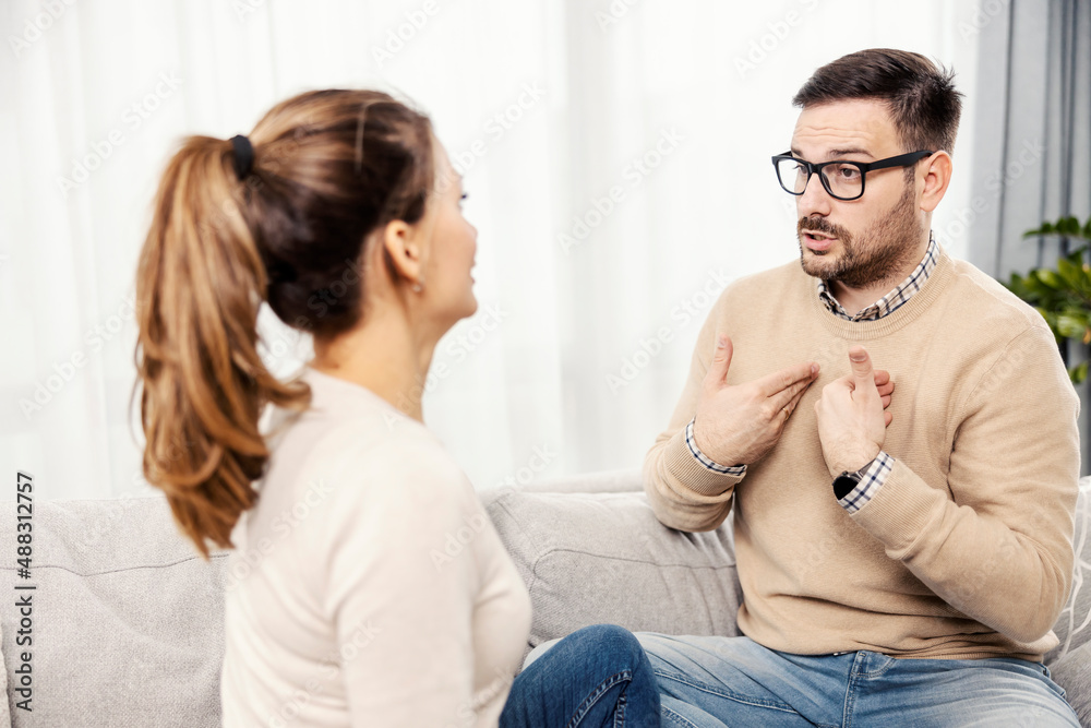 A couple having fight while sitting on the sofa at their home. A couple having fight while sitting on the sofa at their home.