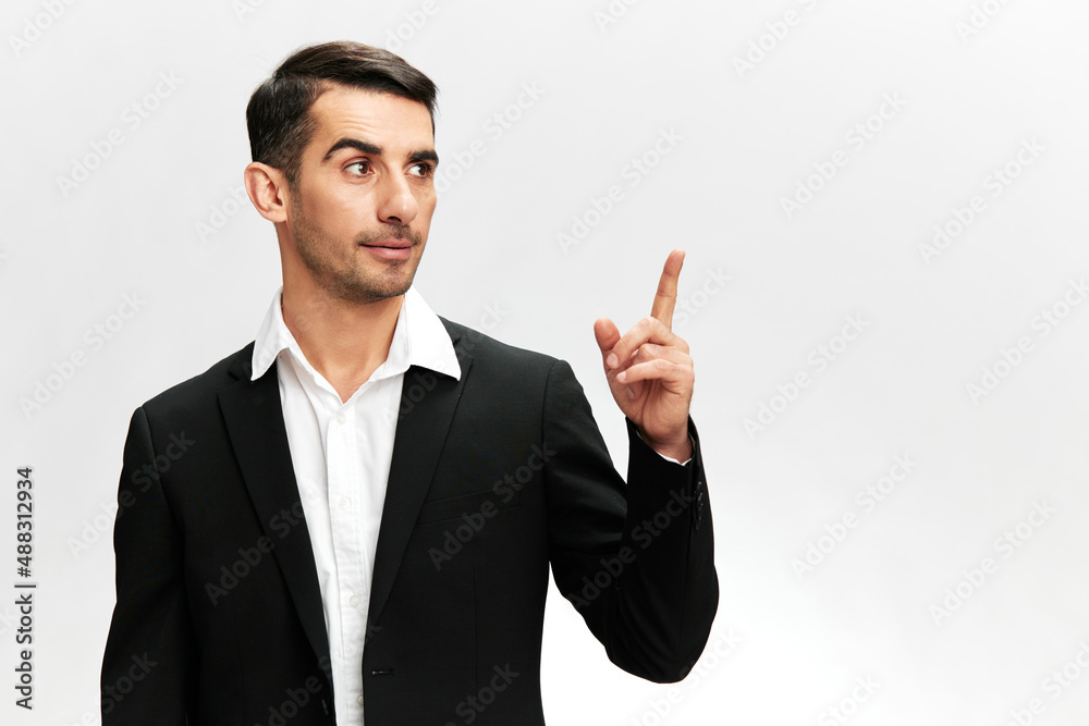 business man showing index finger up in black business suit work successful trader isolated. Copy space business man showing index finger up in black business suit work successful trader isolated. Copy space