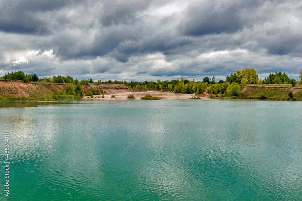 lake in the limestone quarry on a cloudy gloomy summer day
