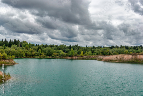 lake in the limestone quarry on a cloudy gloomy summer day