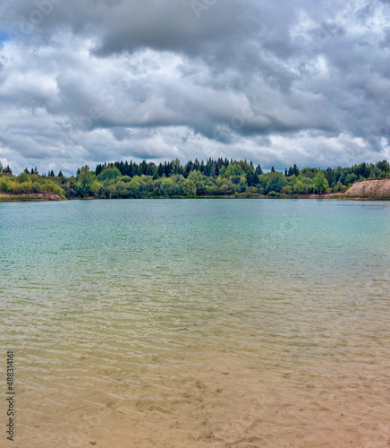lake in the limestone quarry on a cloudy gloomy summer day