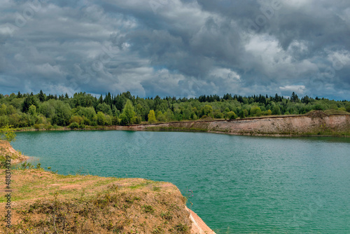 lake in the limestone quarry on a cloudy gloomy summer day