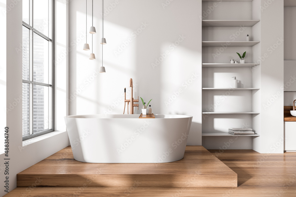 Light bathroom interior with bathtub and rack with towel, window Light bathroom interior with bathtub and rack with towel, window