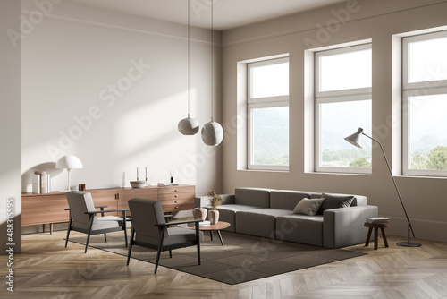 Living room interior with couch and armchair with commode near panoramic window © ImageFlow