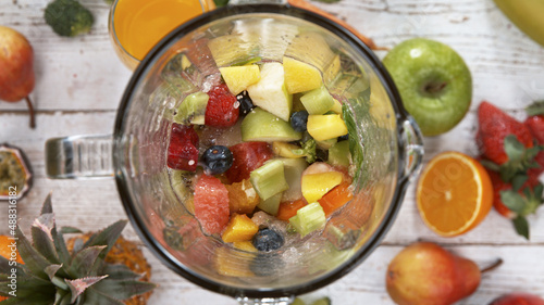 Fresh fruit and vegetables smoothie blended in blender  top view. Healthy eating concept.