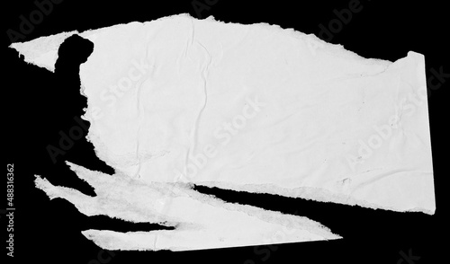 White paper torn piece isolated on black background. Dirty wrinkled glued paper poster texture photo