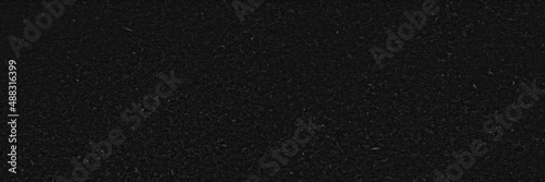 Black paper texture background. Recycled grainy craft paper surface