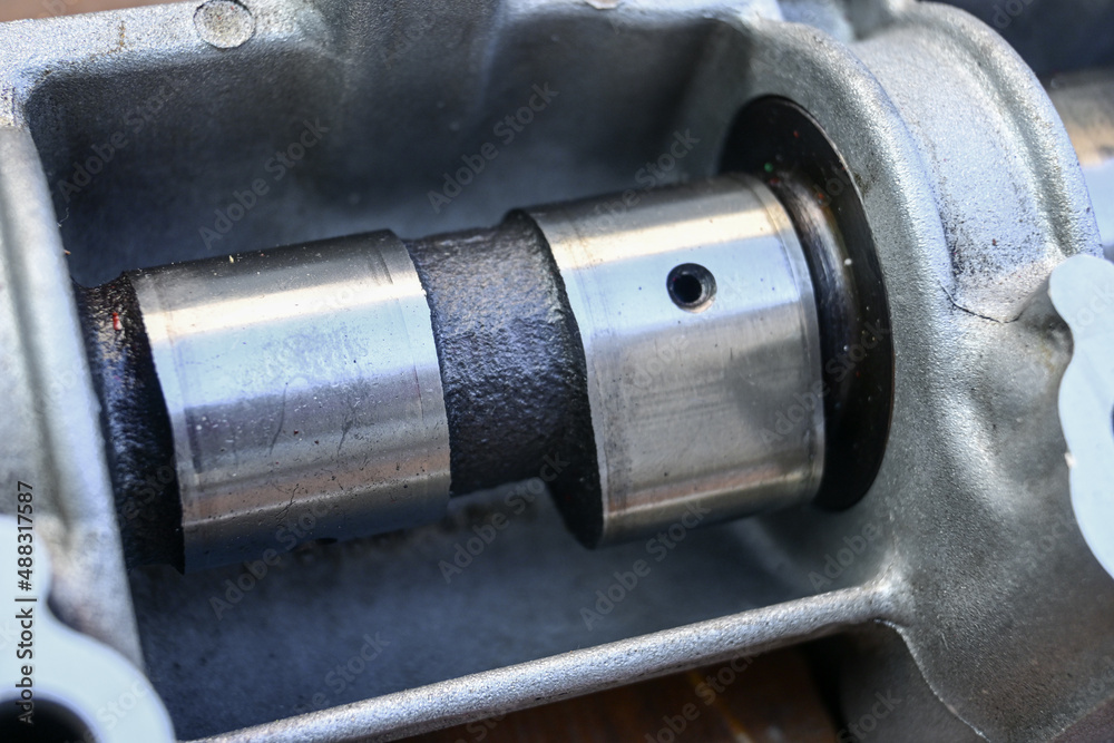 cam lobes. car camshaft. camshaft in body. closeup. cam lobes. car camshaft. camshaft in body. closeup.