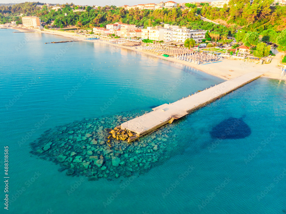 top view of the turquoise sea, sandy beach and pier