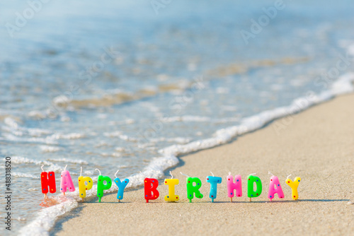 Canvas Print Happy birthday colorful candles on a beach