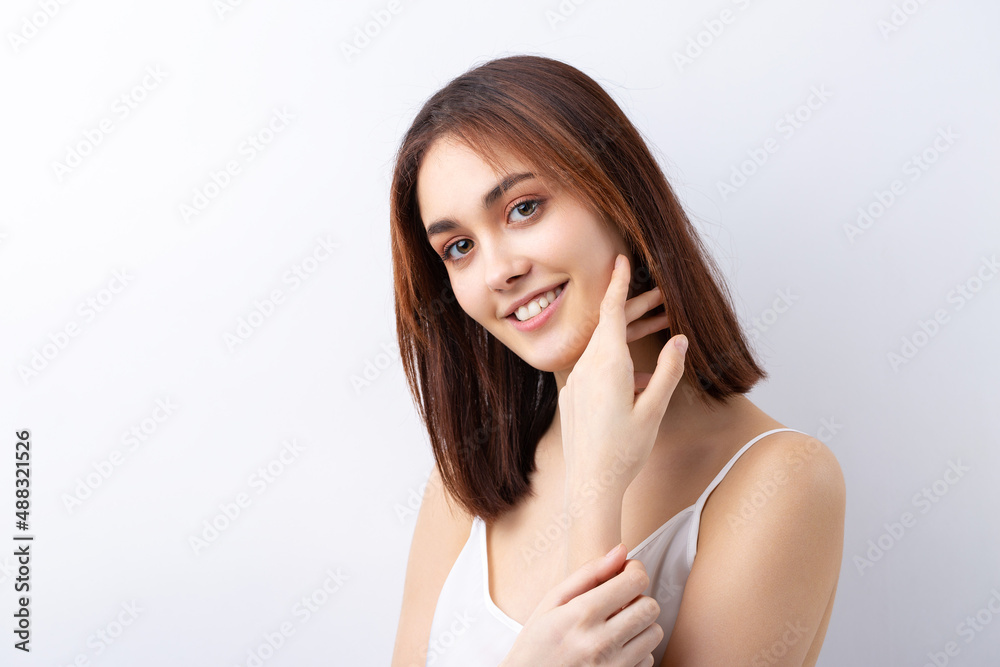 Beautiful smiling woman with clean skin, natural make-up and white teeth on a gray background Beautiful smiling woman with clean skin, natural make-up and white teeth on a gray background