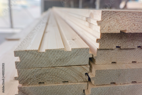 Tongue and groove wooden boards storage. Batten boards with grooves and tongues in market warehouse