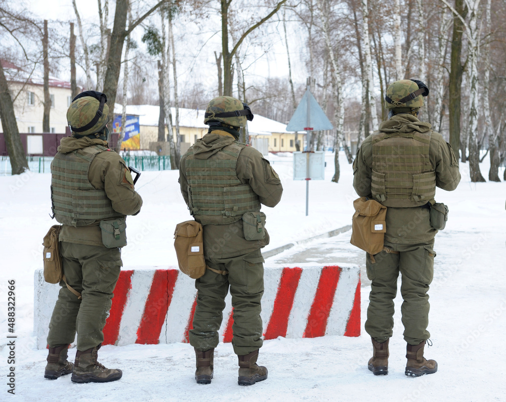 Soldiers taking position guarding roadblock. Military range, Ukraine Soldiers taking position guarding roadblock. Military range, Ukraine