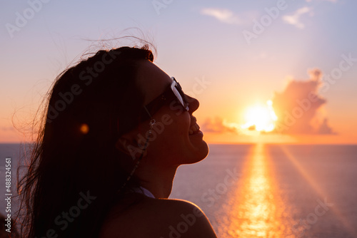 woman enjoying sunset above the sea