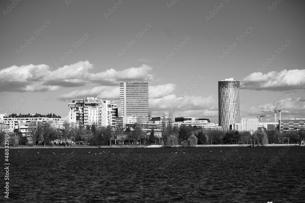 the northern part of Bucharest seen from the other shore of Herastrau Lake. photo during the day.
