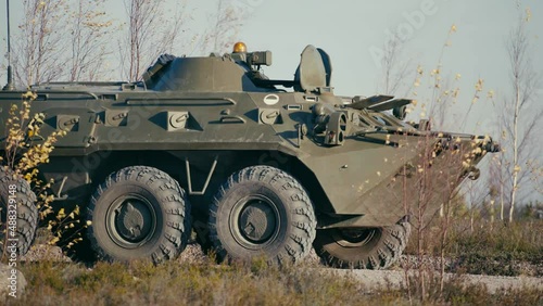 Close-up of an armored personnel carrier of the Russian army riding on the road.