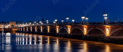 Panoramic view of stone bridge by night in Bordeaux