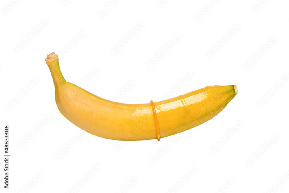 A banana with a condom on it isolated on white background. A banana with a condom on it isolated on white background.