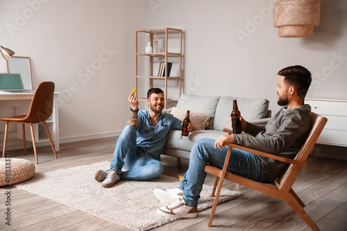 Male friends with bottles o...