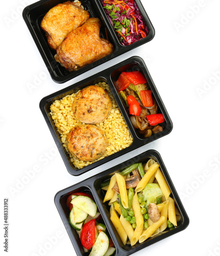 Containers with delicious food on white background