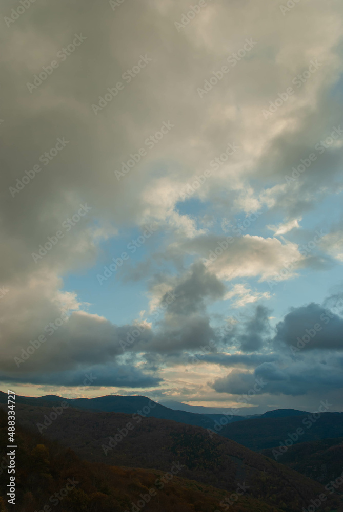 Mountainous landscape with a cloudy sunset sky Mountainous landscape with a cloudy sunset sky