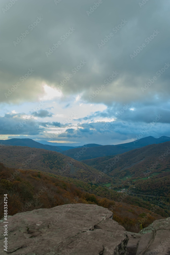 Mountainous landscape with a cloudy sunset sky