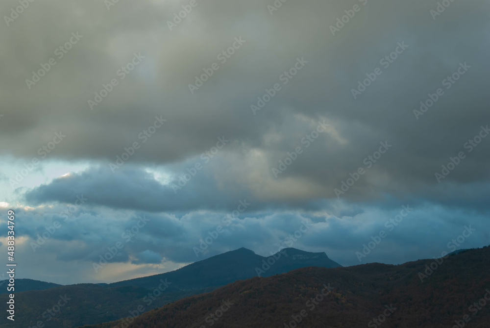Mountainous landscape with a cloudy sunset sky Mountainous landscape with a cloudy sunset sky