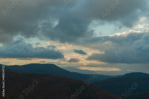 Mountainous landscape with a cloudy sunset sky